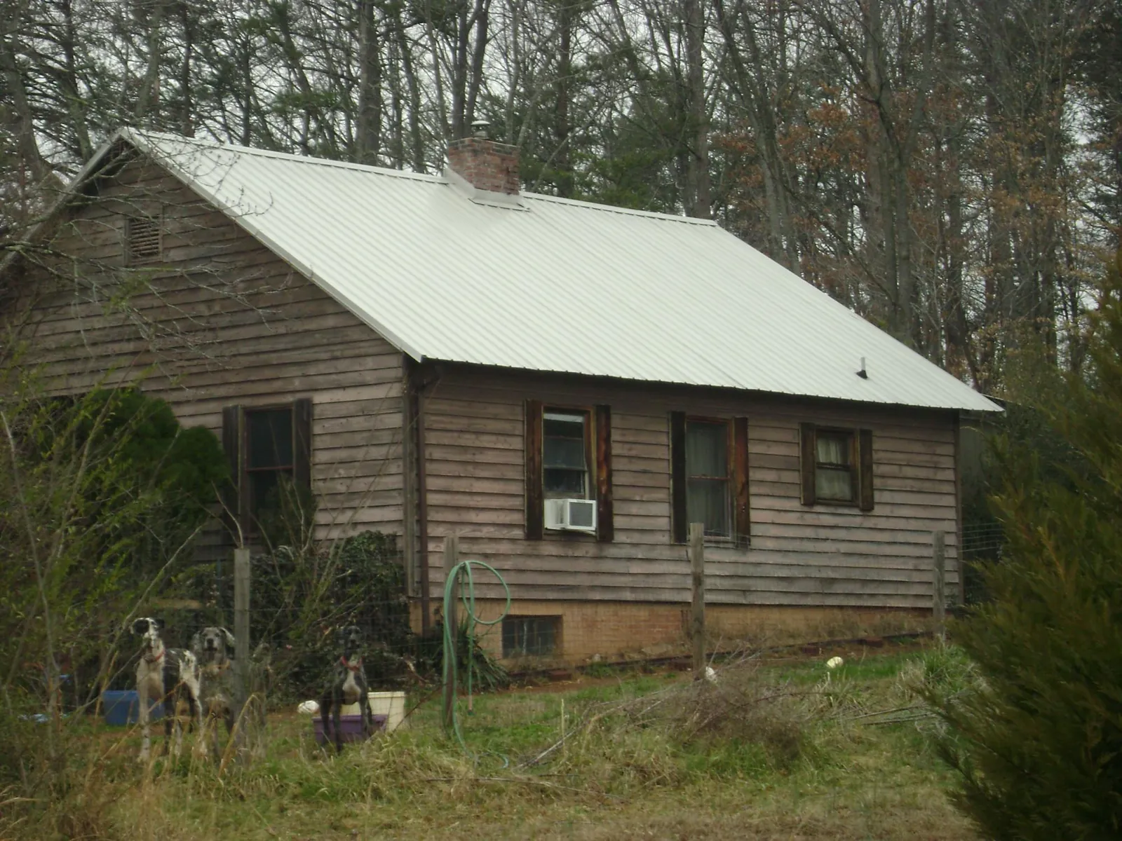 White metal roof on an old wood sided farmhouse, from a Asphalt Shingle Roof Repair job in Conway